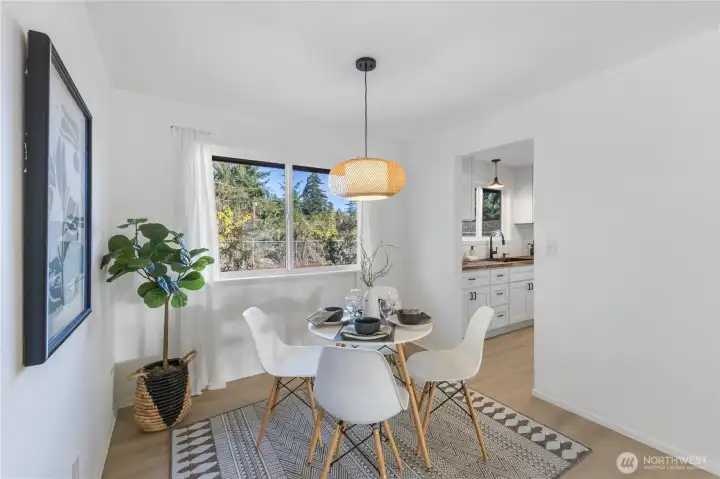 Dining flows into kitchen and living spaces