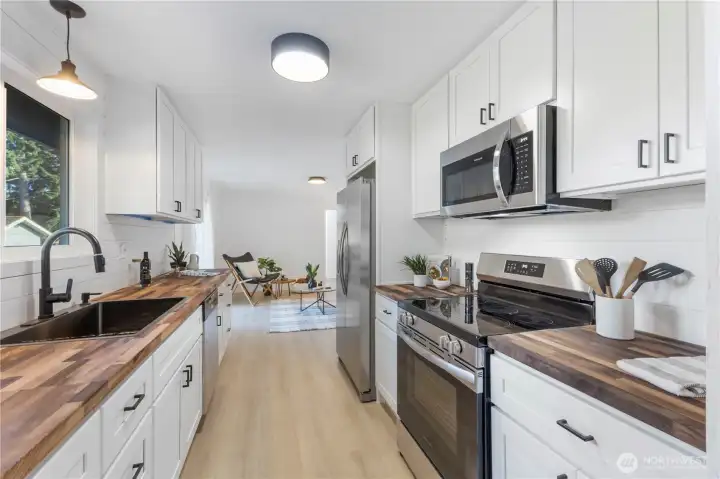 Nice new kitchen with all new stainless appliances and shiplap accents