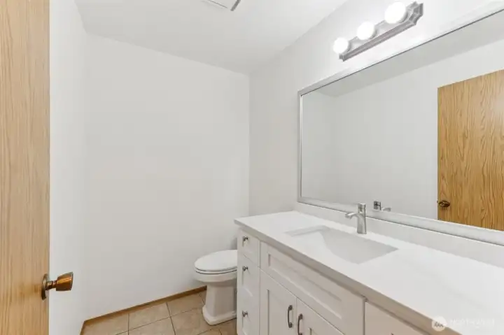 Guest bathroom on the main floor has new vanity and quartz countertops.