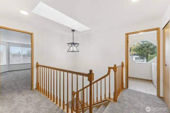 View from top of the landing upstairs.  Brand new carpet throughout and new light fixture.