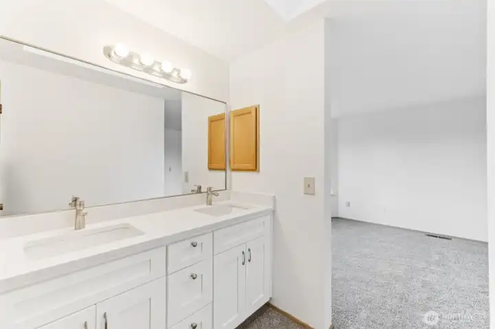 View of primary bathroom looking into the primary bedroom.