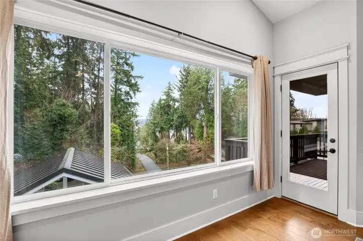 Primary suite has own deck with peekaboo lake views