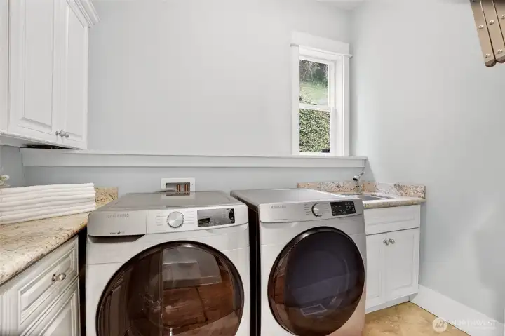 Dedicated spacious laundry room with sink