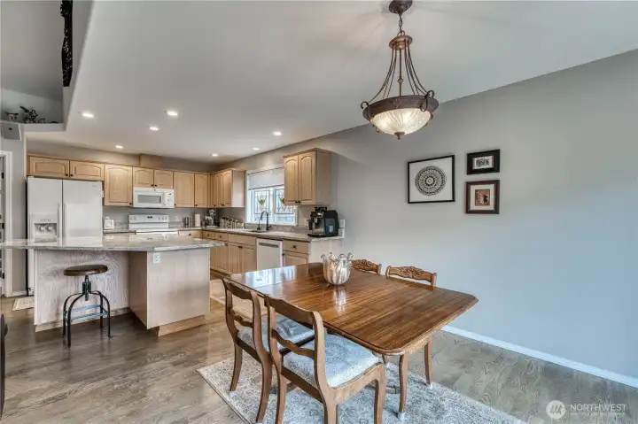 Eating area off kitchen with hardwood floors