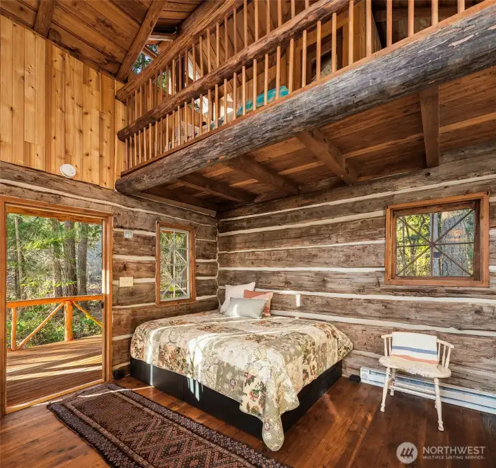 Interior has vaulted ceilings, log walls and wood floors.
