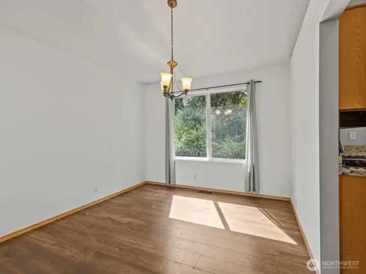 The formal dining room looks out at the greenbelt.