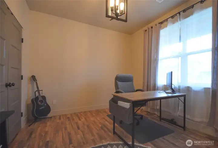 Versatile fourth bedroom or home office featuring custom doors and a spacious closet complete with built-in organizers for added functionality. 10x10