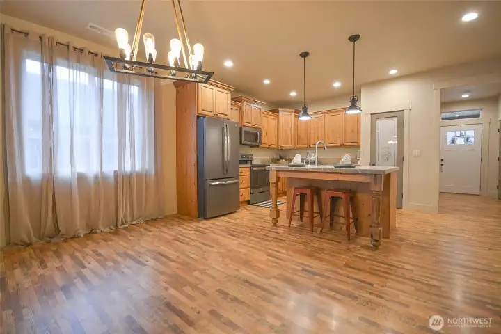 Dining area with beautiful modern lighting. the large windows keep it bright.