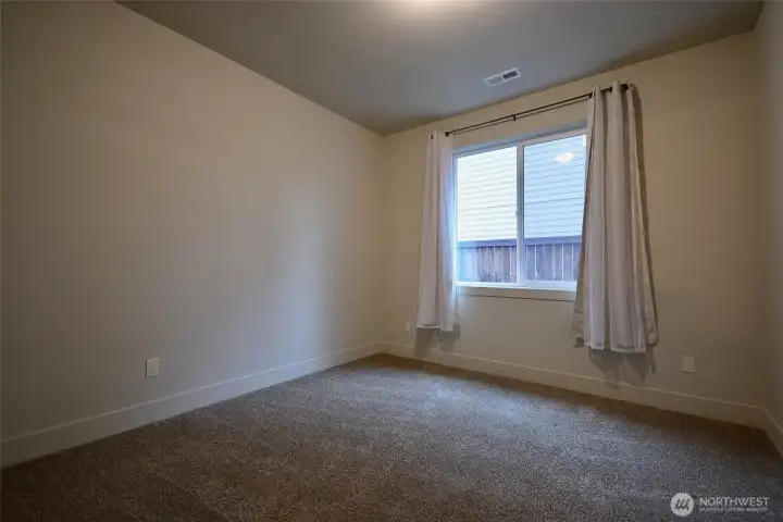 Spacious second bedroom measuring 10.9 x 11, offering ample room and featuring a closet with built-in wood organizers. Designer doors.