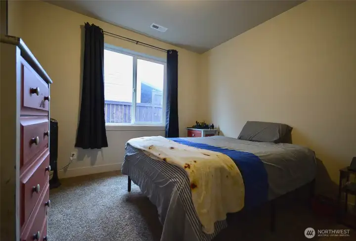 Comfortable third bedroom measuring 10.8 x 11, featuring designer doors and a closet with built-in wood organizers.