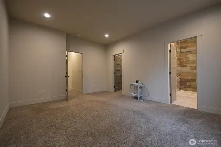 Spacious primary bedroom featuring coffered ceilings and designer doors, along with a huge walk-in closet complete with custom wood organizers. Includes a private en-suite bathroom for added comfort and convenience. 15.98 X12.98 .