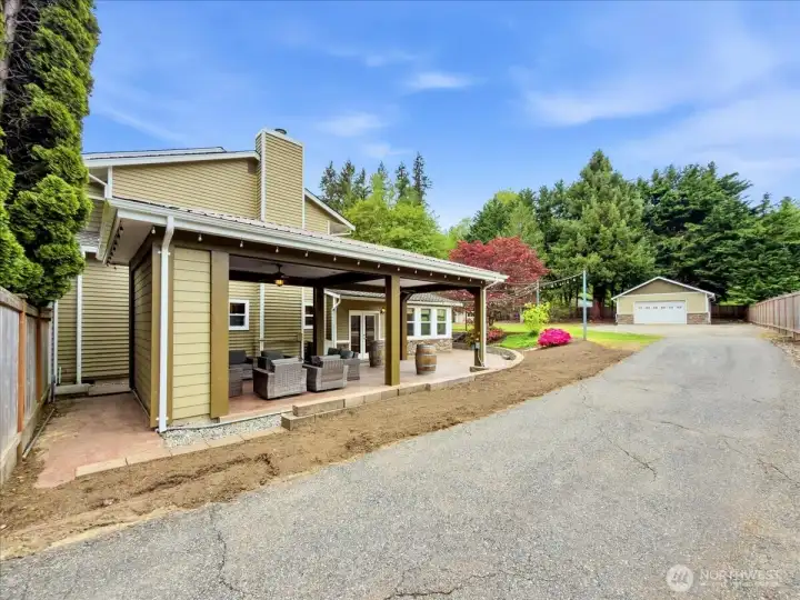 The backyard features a covered area with fans and TV perfect for entertaining no matter the weather. RV parking. A detached garage/shop and an additional shed.