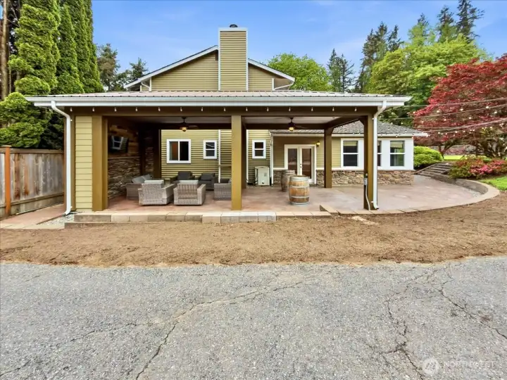 The backyard features a covered area with fans and TV perfect for entertaining no matter the weather. RV parking. A detached garage/shop and an additional shed.