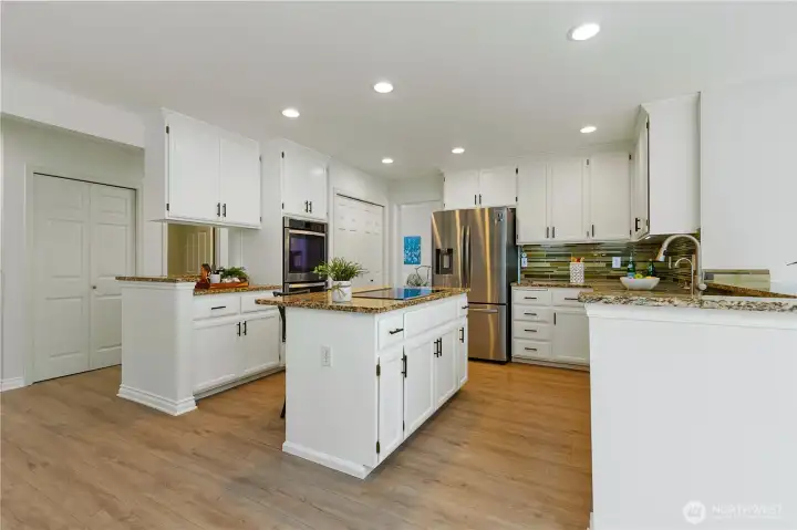 Kitchen with updated cabinets, large pantry, double oven, French door refrigerator and all stainless steel appliances