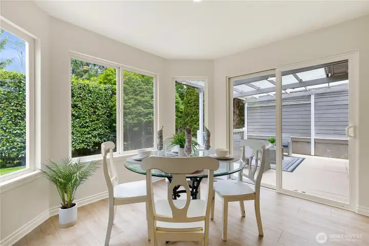 Kitchen eating area with access to covered deck and back yard behind