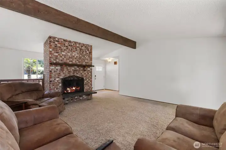 Large living room offset from dining area with a wood fireplace for those Washington rainy days indoors. Large living room offset from dining area with a wood fireplace for those Washington rainy days indoors.