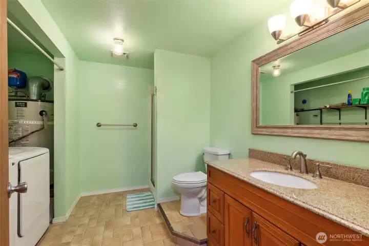 Lower bathroom area with laundry. Lower bathroom area with laundry.