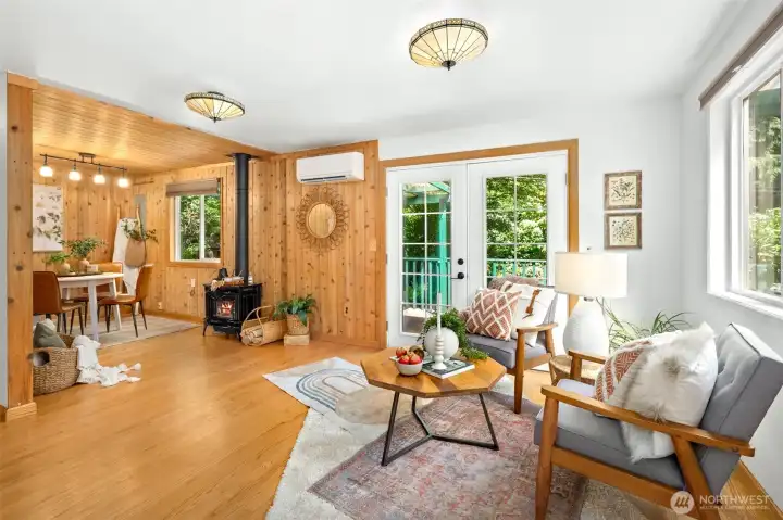 Open living room with french doors to private deck
