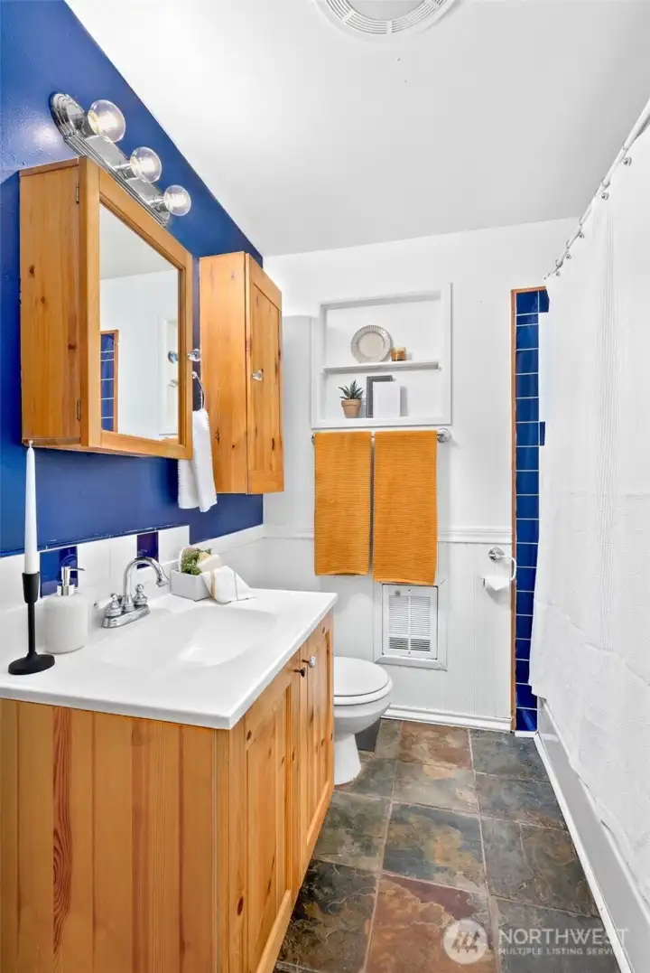 Full bathroom with tile floors and a linen closet
