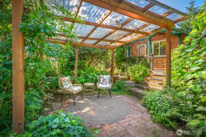 Covered private patio area with views of the mature garden