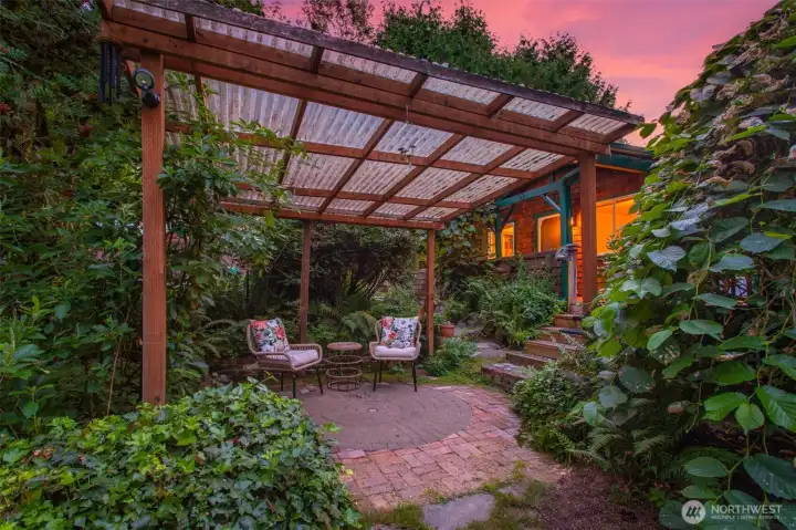 Covered private patio area with views of the mature garden