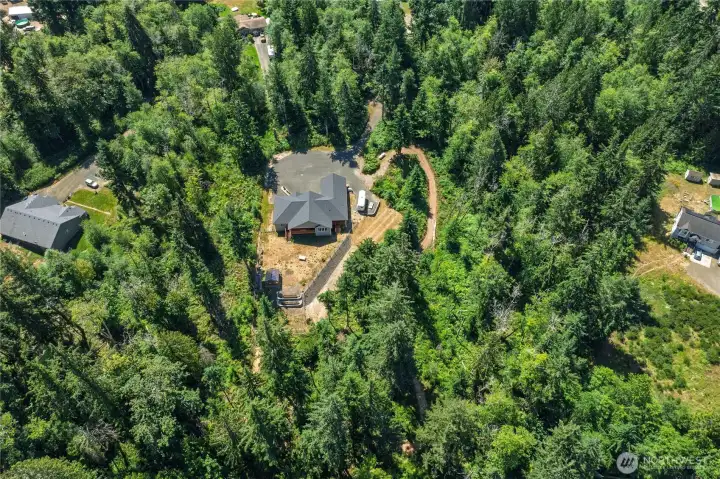 This aerial captures a portion of the trail prior to it getting into denser forest area. View of fenced-in back yard and private setting. This aerial captures a portion of the trail prior to it getting into denser forest area. View of fenced-in back yard and private setting.
