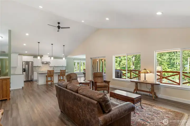 Sprawling great room with vaulted ceilings and a wall of windows that drench the living space with natural light creating an uplifting atmosphere. Sprawling great room with vaulted ceilings and a wall of windows that drench the living space with natural light creating an uplifting atmosphere.