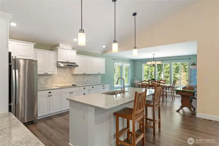 Quartz counters, with newly installed tile backsplash & pendent lights, stainless appliances, double ovens, and bar counter create an attractive and functional cooking environment. Quartz counters, with newly installed tile backsplash & pendent lights, stainless appliances, double ovens, and bar counter create an attractive and functional cooking environment.