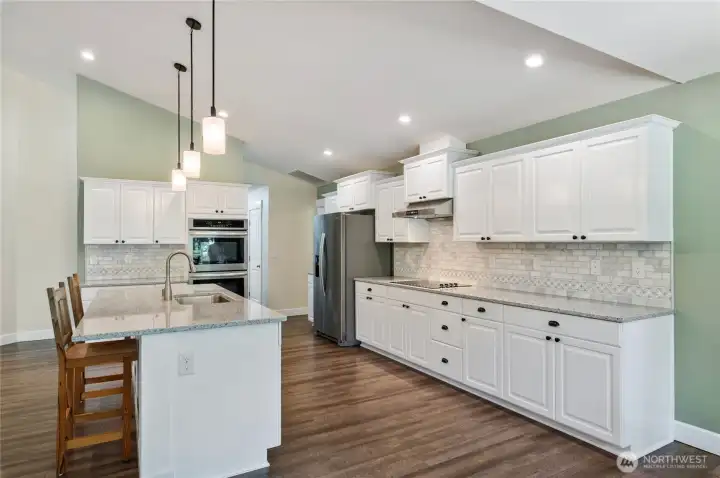 Extensive cabinet storage for small appliances and cookware. Abundant counter space ensures multiple cooks can prep simultaneously. The walk-in pantry is just beyond the double ovens and offers a wealth of additional storage space. Extensive cabinet storage for small appliances and cookware. Abundant counter space ensures multiple cooks can prep simultaneously. The walk-in pantry is just beyond the double ovens and offers a wealth of additional storage space.