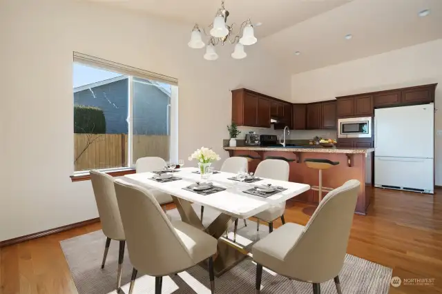 Dining Area next to breakfast bar - Open Concept Bright & Airy to Living Area with Gas Fireplace & Easy Access to Outdoor Deck - Virtually Staged to give you a sense of the rooms potential.