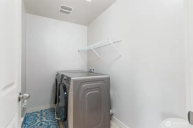 Upstairs laundry room with new washer/dryer that stay with the home