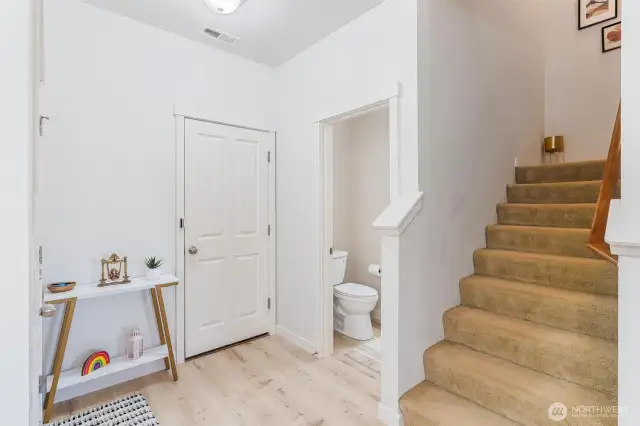 Foyer, powder room, access to garage and bottom of staircase