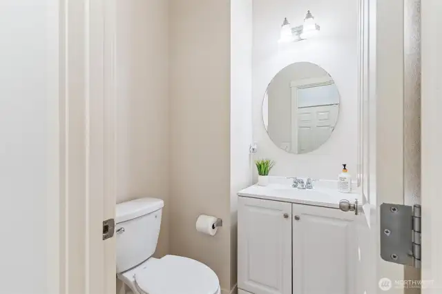 Powder room on first floor with updated vanity and flooring