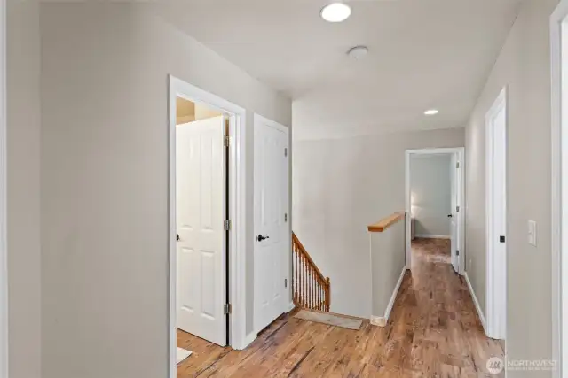 Upstairs hallway with primary bed at the end of the hall