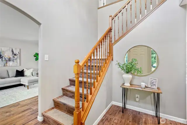Lovely entry, on the left formal living and dining room. On the right you will find the powder bath, laundry room and access to the garage, hallway to the kitchen and open living room.