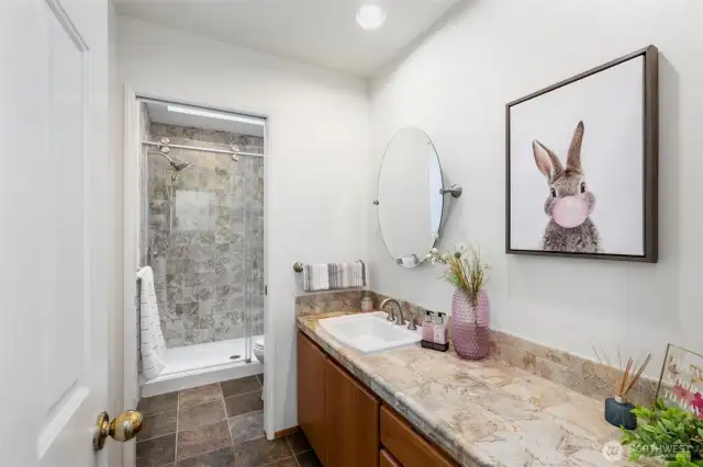 Full bath with walk-in custom tile shower, lots of great space, skylight.