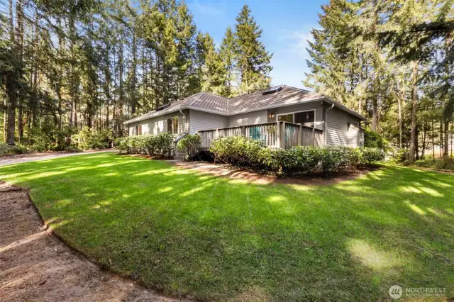 Lot is fully landscaped and has mature plantings that are low care. Rhodies, azaleas, & more plus a ring of trees for privacy.