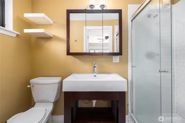 Primary bath with large walk in shower, bidet, updated sink and medicine cabinet.