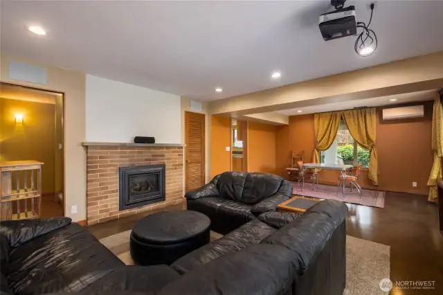 Let's go to the Huge downstairs unit ! Living area with large dining or office space. Gas Fireplace, projection TV and tons of charm ! TV system stays.