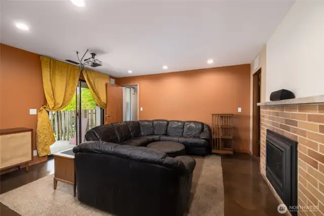 Downstairs LARGE living area with projection TV, Gas fireplace. There is a big slider leading to another private space outside for this unit.