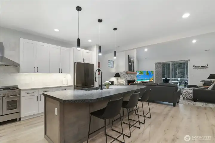 Gourmet kitchen with oversized leathered granite island open to great room