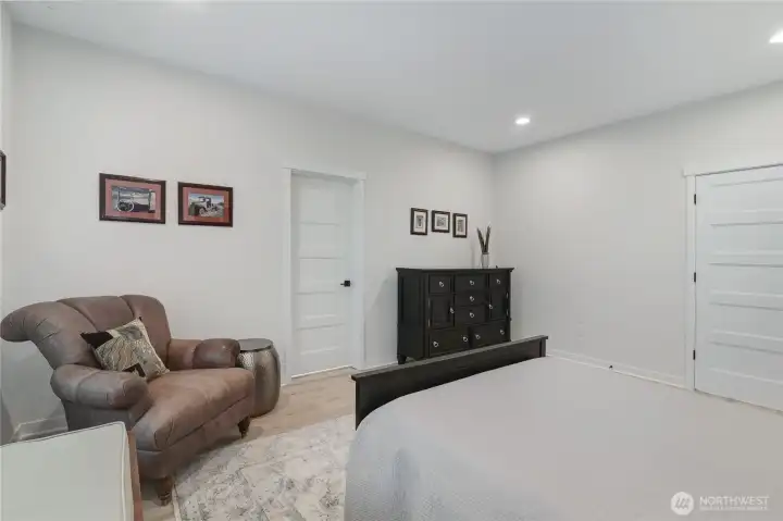 Primary suite showing private bath and walk-in closet entrances