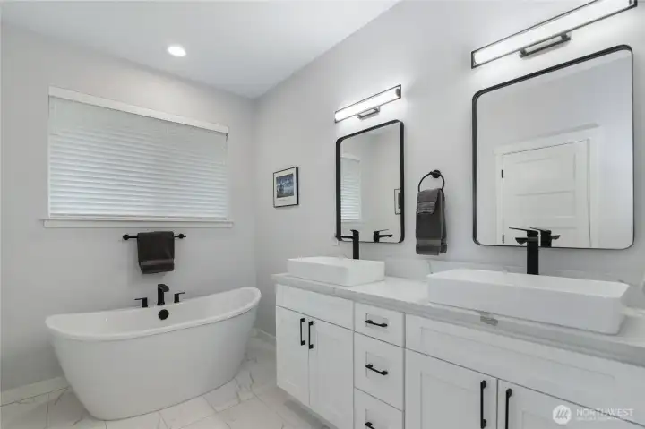 Primary en suite features beautiful soaking tub, double vanity, and high quality features