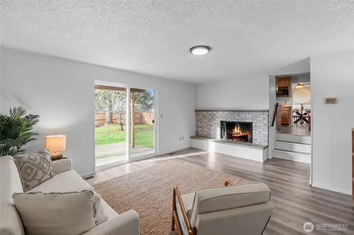 FAMILY ROOM | What great connection! Up the steps into the kitchen on through to the dining room. DISCLAIMER: Fire was photoshopped, but to the sellers' knowledge the fireplace is functional though they didn't use it.