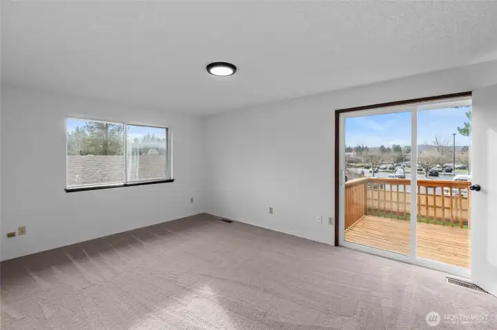 PRIMARY BEDROOM | Located at the back of the home this bedroom features a private balcony as well as a bathroom and walk-in closet. You'll love the fresh paint and NEW carpet.