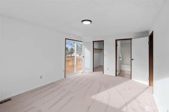 PRIMARY BEDROOM | Another view of the primary bedroom showing the walk-in closet and bathroom.