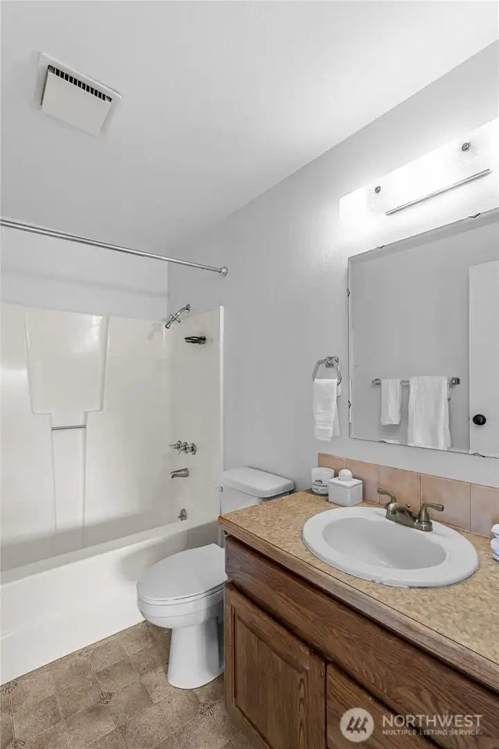 PRIMARY BEDROOM BATH | This full bath is conveniently located off the primary bedroom.