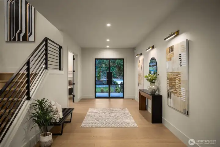 Large foyer featuring an art wall and 4" can lighting