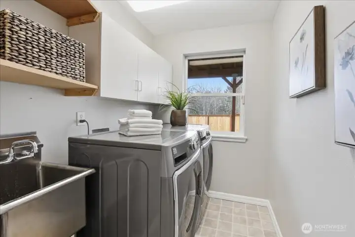 Washer/Dryer stay! Laundry with storage, stainless sink, and natural light