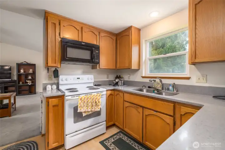 The efficient kitchen features updated floors and countertops, and fresh new paint